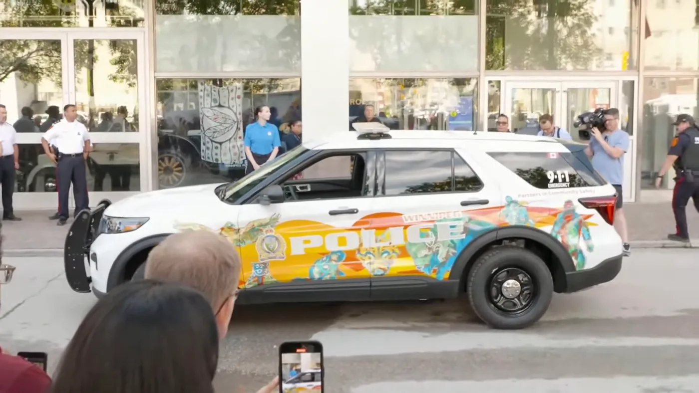 The cruiser driving past the crowd at the unveiling